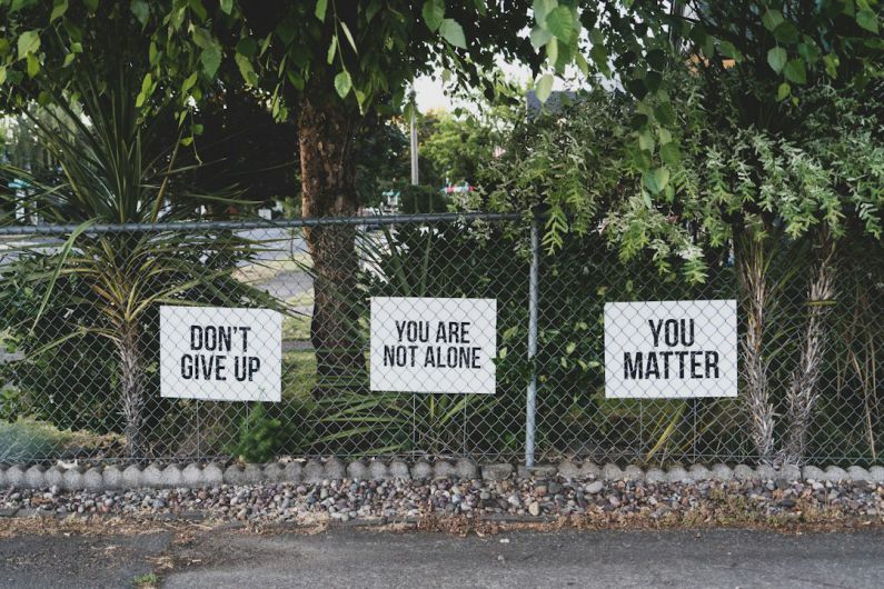 Mental Health Awareness - don't give up. You are not alone, you matter signage on metal fence