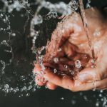 Clean Water - a person holding their hands under a stream of water