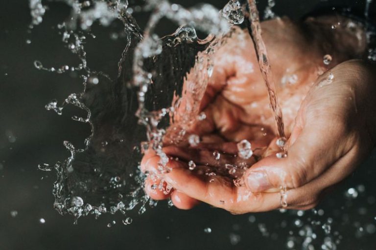 Clean Water - a person holding their hands under a stream of water