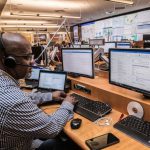 Emergency Response - man in black and white checkered dress shirt using computer