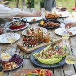 Shared Dinner - group of people eating on backyard