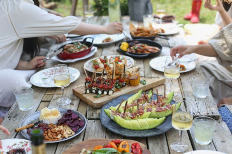 Shared Dinner - group of people eating on backyard