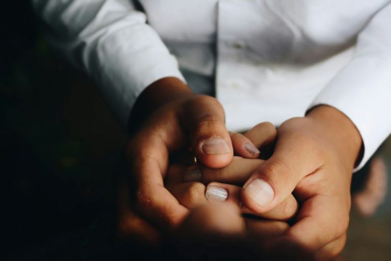 Comforting Hand - person holding hands