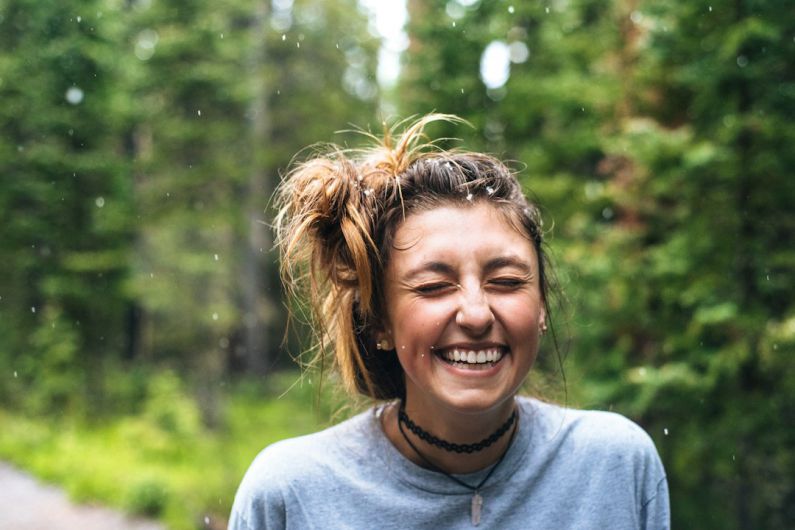 Smiling People - woman smiling near tree outdoor during daytime