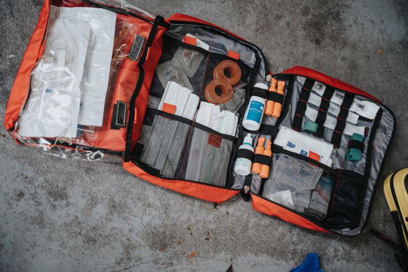 First Aid Kit - orange white and black bag