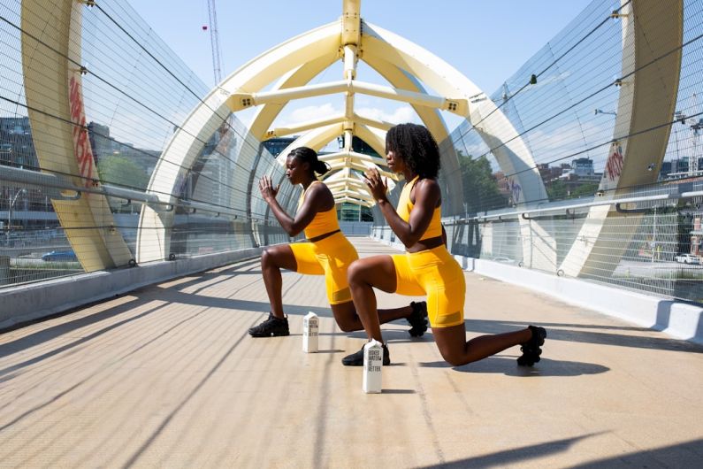 Fitness - woman in yellow shorts sitting on yellow chair