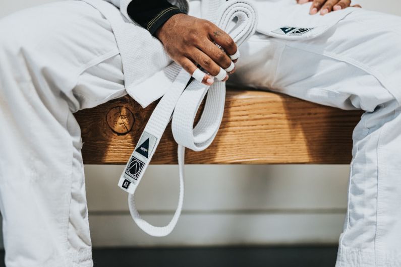 Self-defense - person in white dress shirt holding white plastic bag